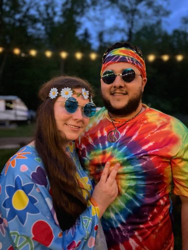 Couple enjoying an evening at Sugar Creek Glen Camping with lights in the background