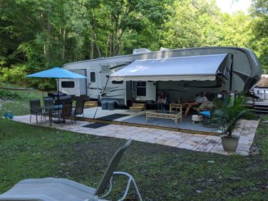 RV campsite with patio, seating area, and outdoor living space at a New York campground
