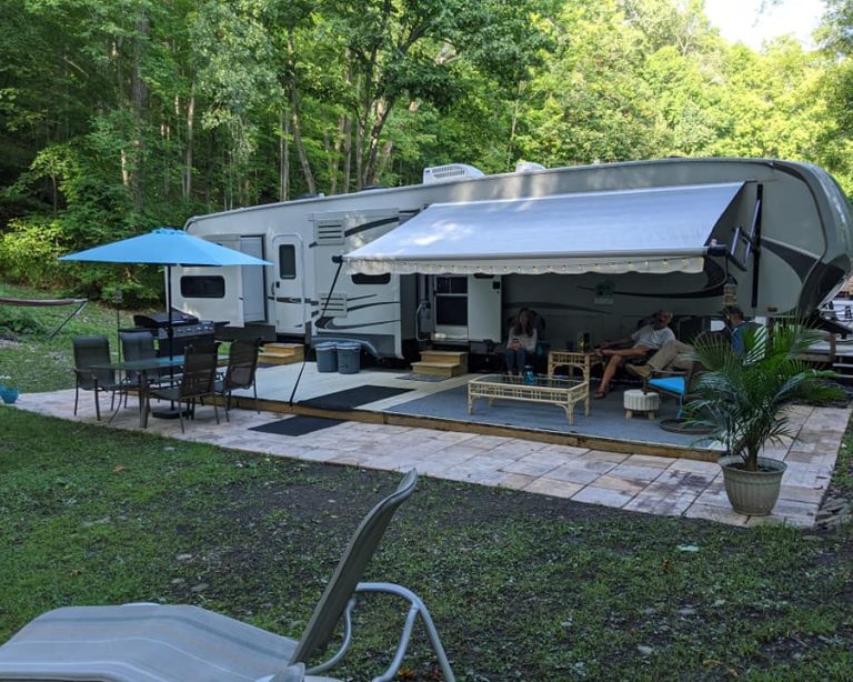 RV campsite with patio, seating area, and outdoor living space at a New York campground