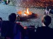 Two children relaxing beside a campfire during an evening at Sugar Creek Glen Campground