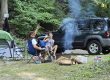 Couple relaxing around a campfire at their campsite during a weekend getaway at Sugar Creek Glen Campground