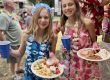 Children enjoying a summer picnic meal during a campground celebration at Sugar Creek Glen Campground