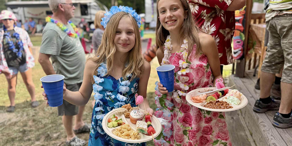 Enjoying the Flavors of Summer at Sugar Creek Glen Campground Children enjoying a summer picnic meal during a campground celebration at Sugar Creek Glen Campground